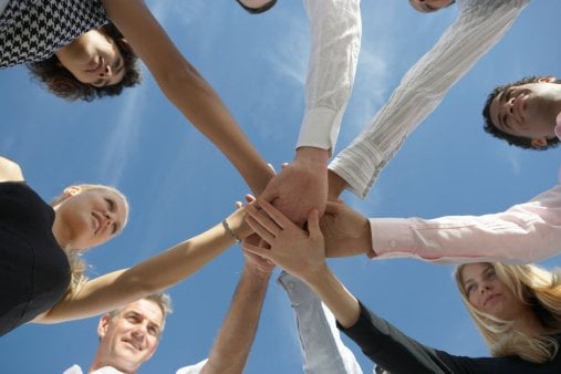 Group of people holding hands, depicting the OECD members. 