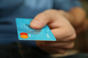 Person using credit card in Central America