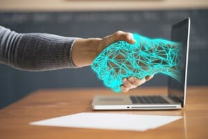 person shaking hands with a computer