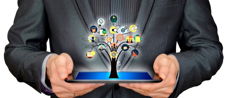 Man holding tablet with icons: representation of opportunities to do business in Chile and India
