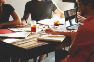 Three people sitting at a desk discussing their market entry strategy in Chile.