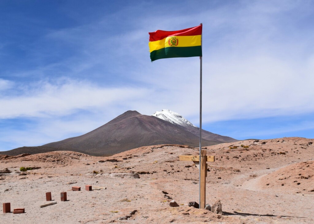 A mountain in Bolivia with the national flag.