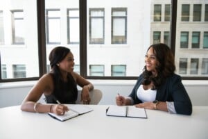 Two women discussing compliance for their NGO in Peru