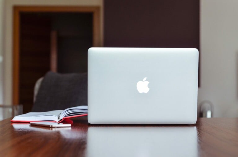 Apple laptop sitting open at desk