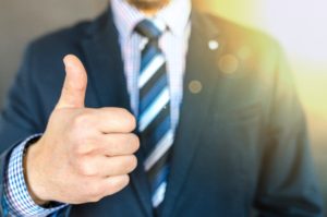 Man in business suit giving thumbs up