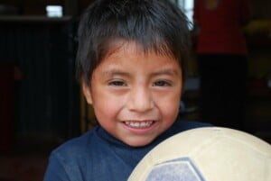 A child holding a football in Bolivia