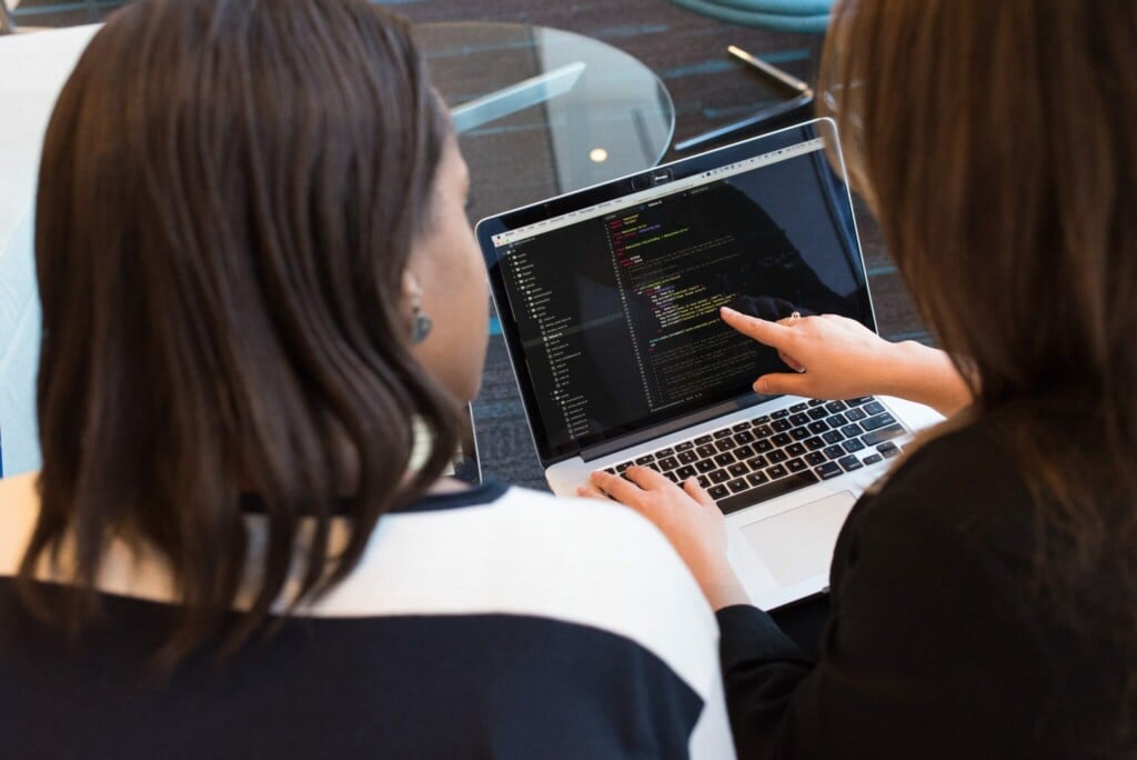 Two women looking at a computer screen