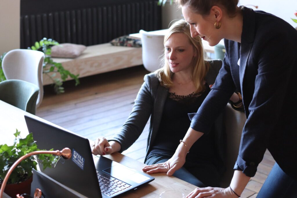 Two women using a laptop