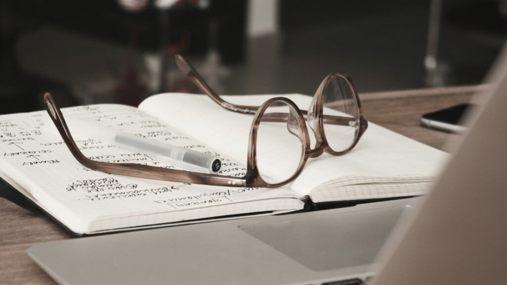 Glasses on top of a notebook.