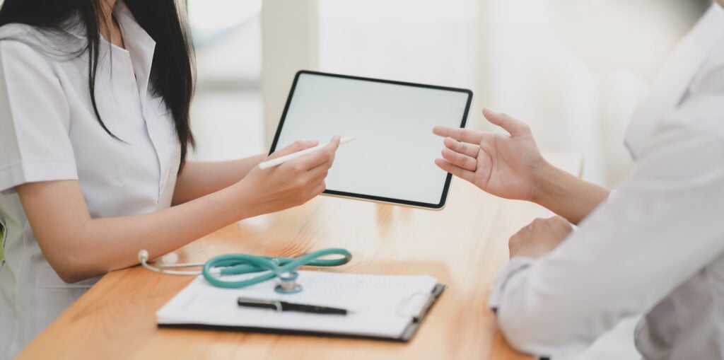 Doctors using tablet to carry out digital health practices