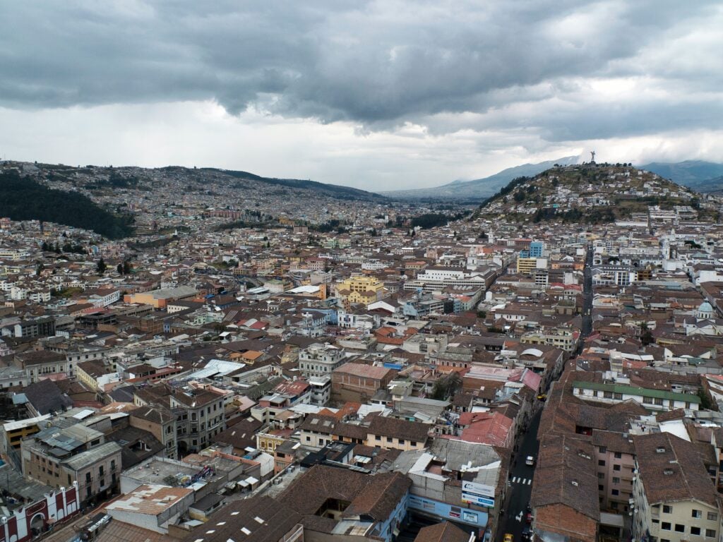 Aerial view of Quito, Ecuador, representing a city where investors interested in aorender on product registration in Ecuador establish their market presence.