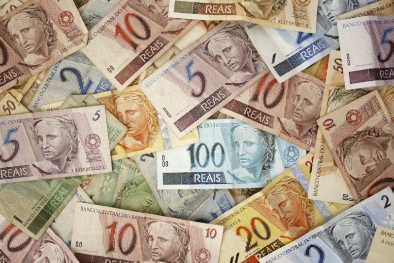 Uma foto de notas bancárias brasileiras, representando a economia fiscal que pode ser feita consultando uma assessoria jurídica corporativa no Brasil.