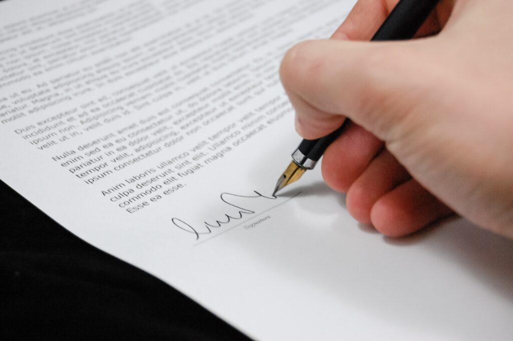 A man signing a document, representing a corporate attorney in Uruguay