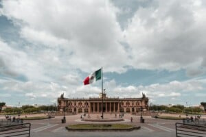 The Mexican flag flying in Monterrey, where you may wish to go through LLC formation in Mexico
