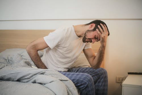A stock photo of a man feeling sick to accompany this guide to employment law in Bolivia