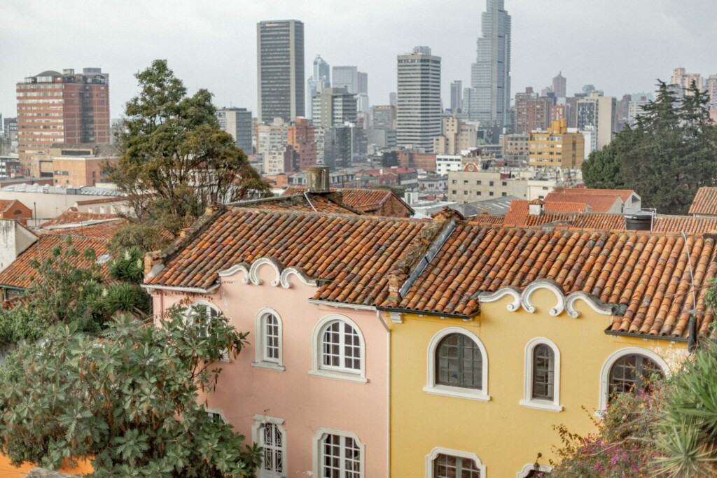 An image of Bogota's old town with the modern business district in the background. If you are planning to invest in Colombia you will need to find a good legal firm or attorney