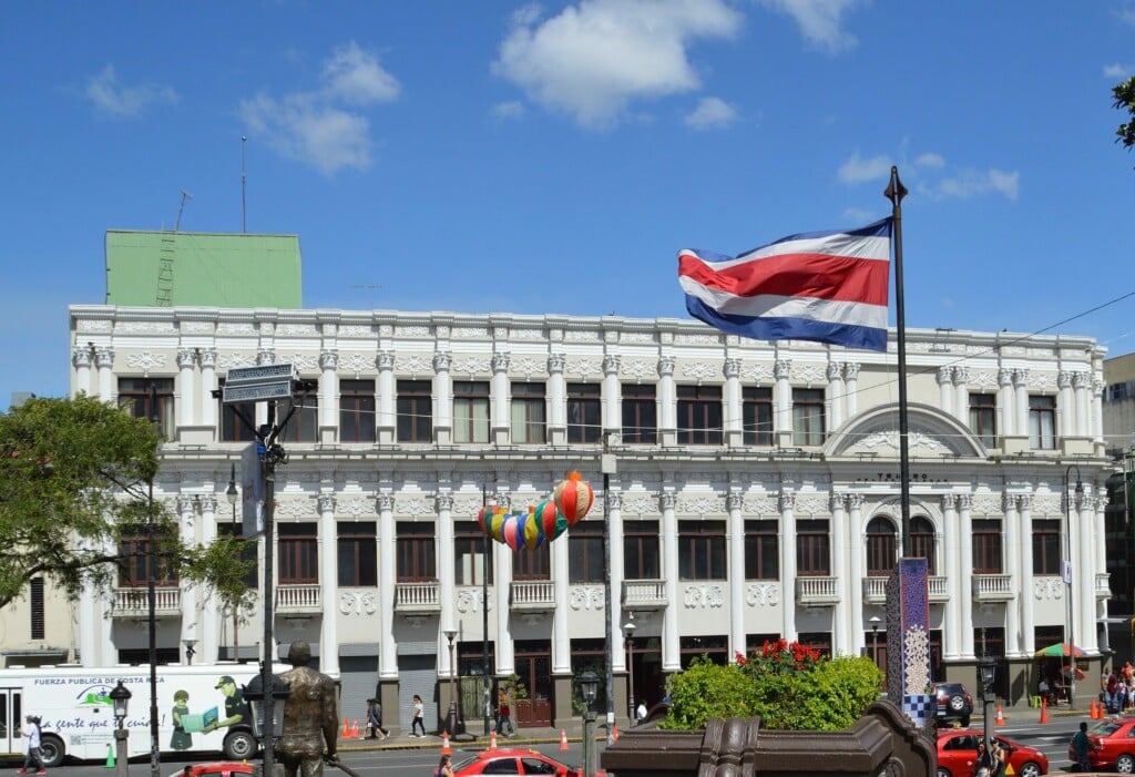 Stock image of a building flying the Costa Rican flag to accompany article on finding a lawyer or legal firm in Costa Rica
