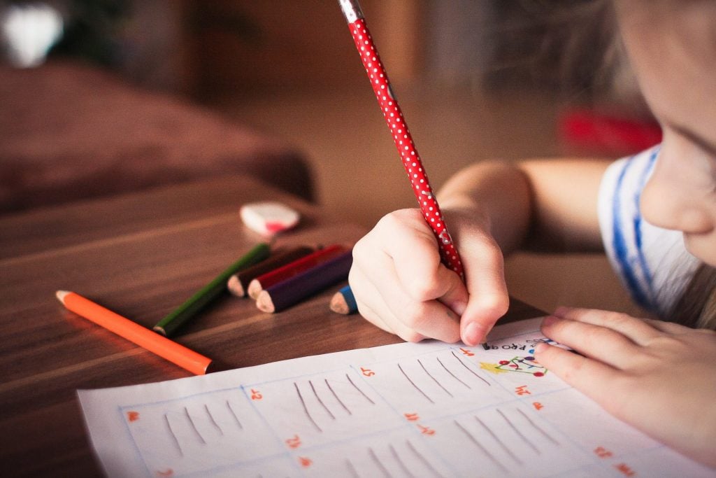 A stock image of a child doing something educational to accompany article on how to start an NGO in Chile