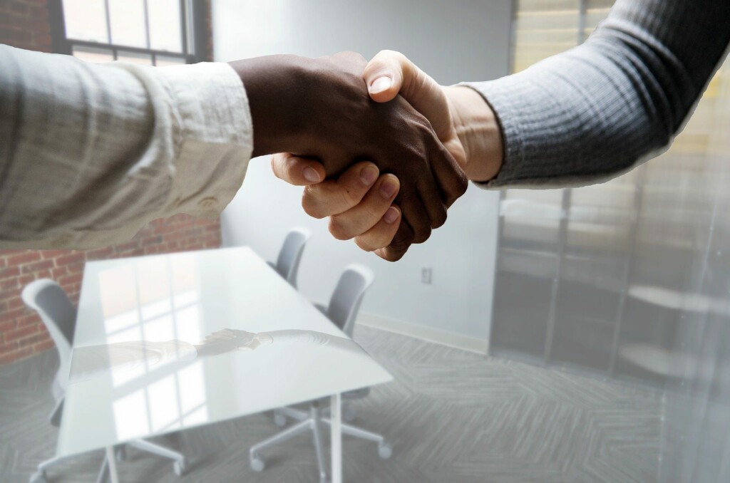 A photo of a handshake representing a PEO in Latin America hiring someone on a client's behalf