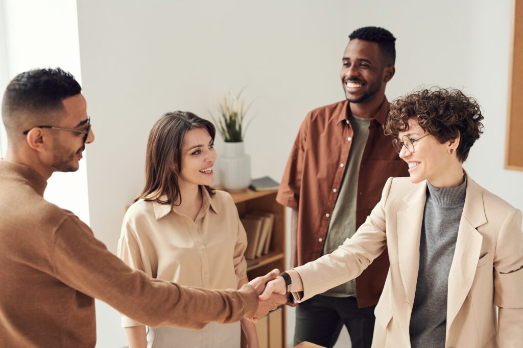 Stock image of people meeting representing the connections a legal firm or legal services provider in Brazil will be able to offer.