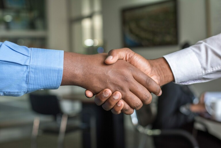 A stock photo of a handshake representing someone recruited by headhunters in Colombia